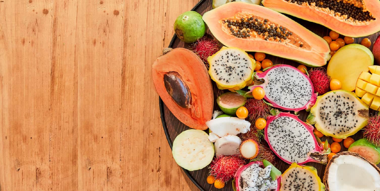 Tropical fruit platter with papaya, dragon fruit, golden berries, mamey.